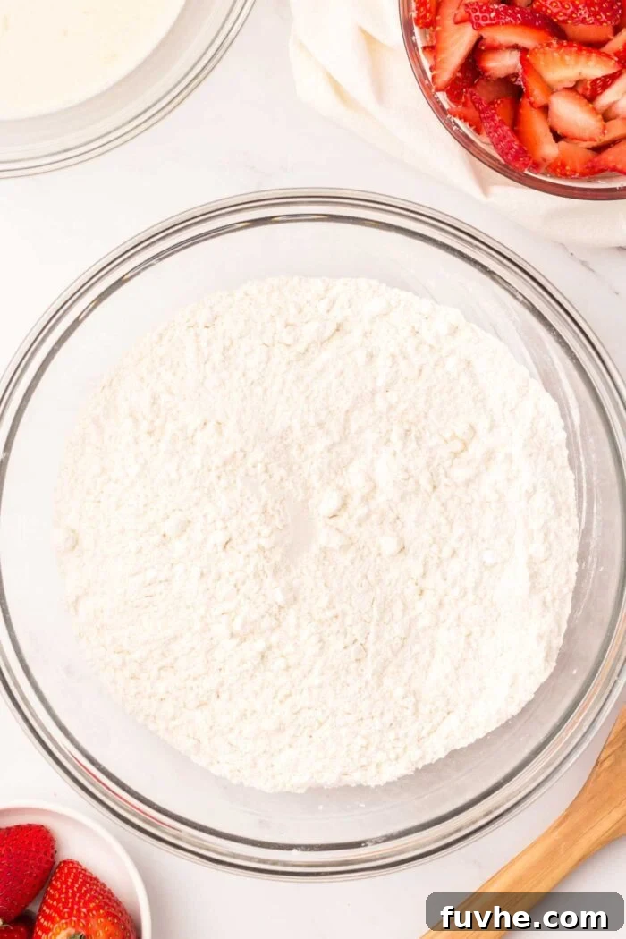 Heavenly Vegan Strawberry Shortcake 6 A large mixing bowl containing all-purpose flour, ready for the next steps in biscuit preparation.