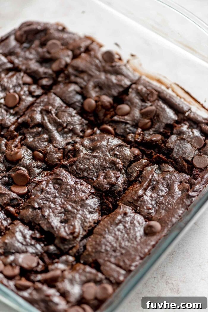 Decadent Vegan Avocado Brownies 8 A pan of avocado brownies with chocolate chips cut into 16 squares.