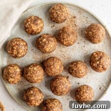 A plate of apple energy balls, perfectly rounded and inviting.