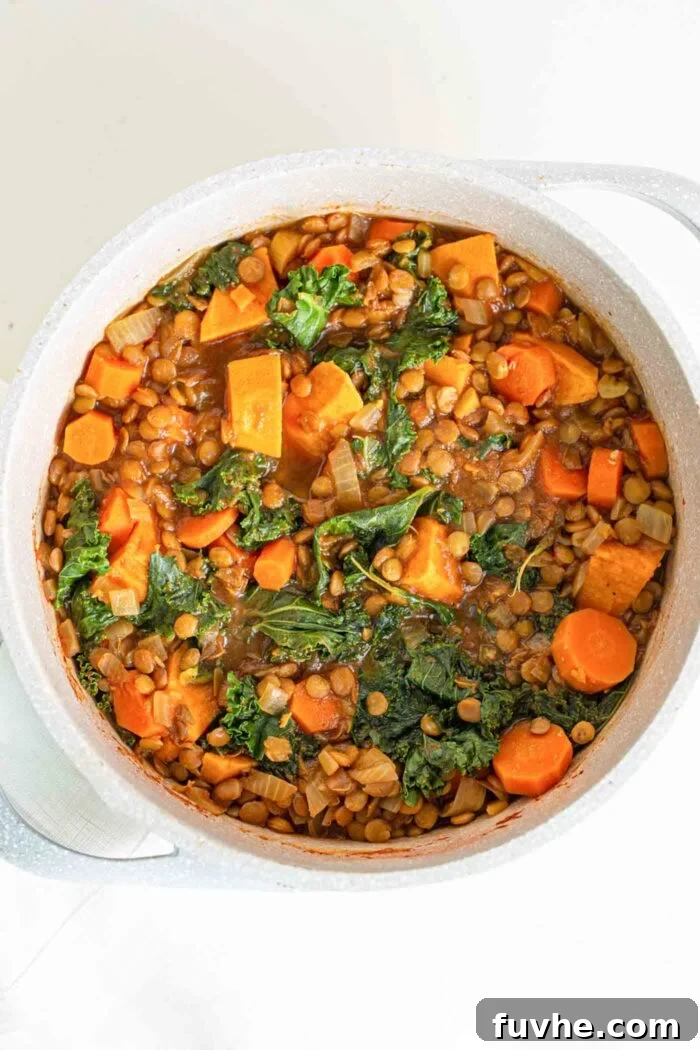 A sweet potato, carrot, lentil stew in a large soup pot.