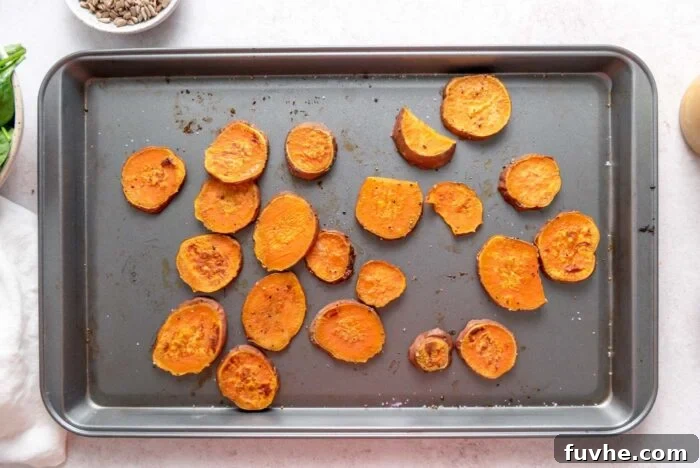 Roasted sweet potato slices on a baking sheet.