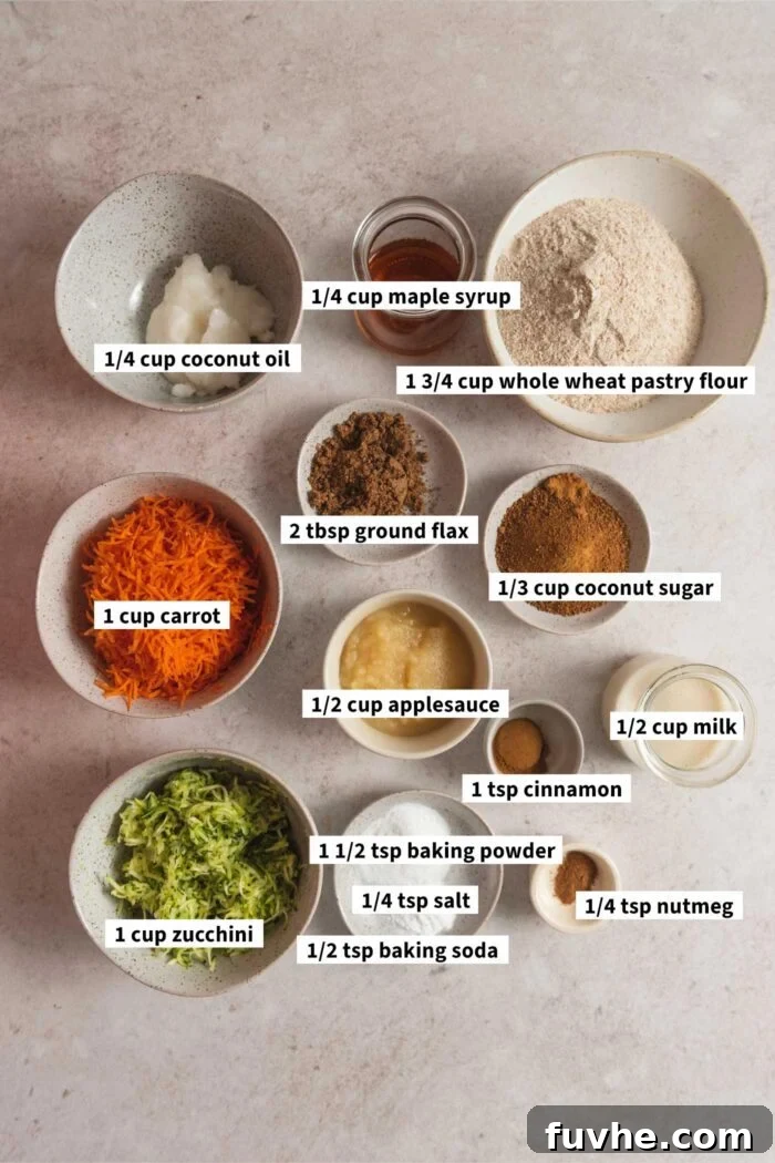 All the ingredients for making healthy vegan carrot zucchini muffins are neatly arranged in various small dishes, each with an identifying text label.