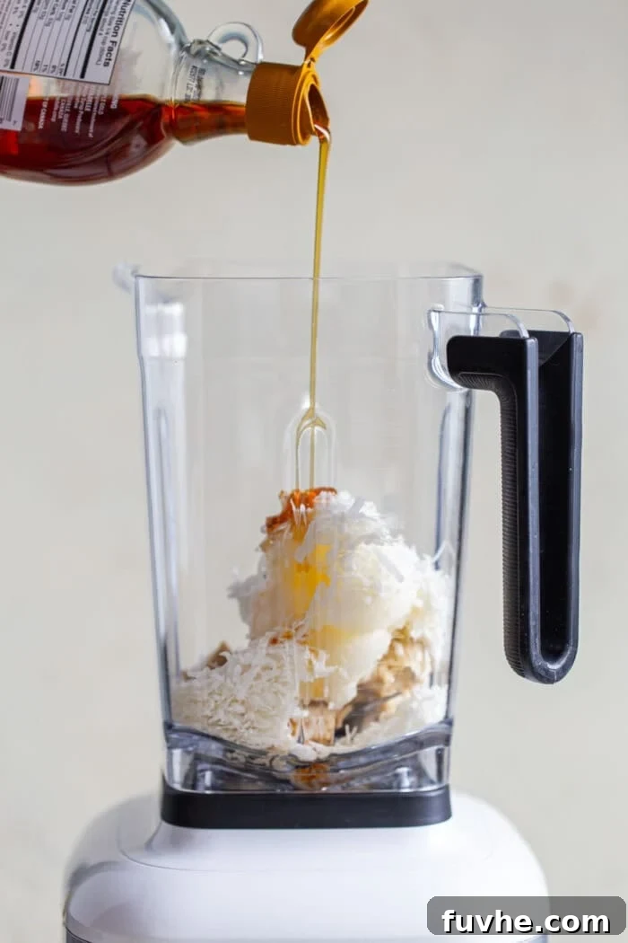 A vibrant mix of ingredients for the no-bake pie filling swirling inside a high-speed blender, moments away from becoming a smooth, creamy concoction.