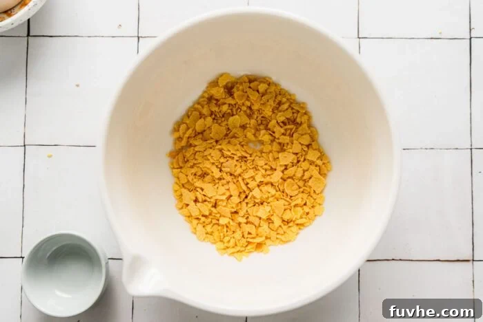 Crushed corn flake cereal in a mixing bowl.