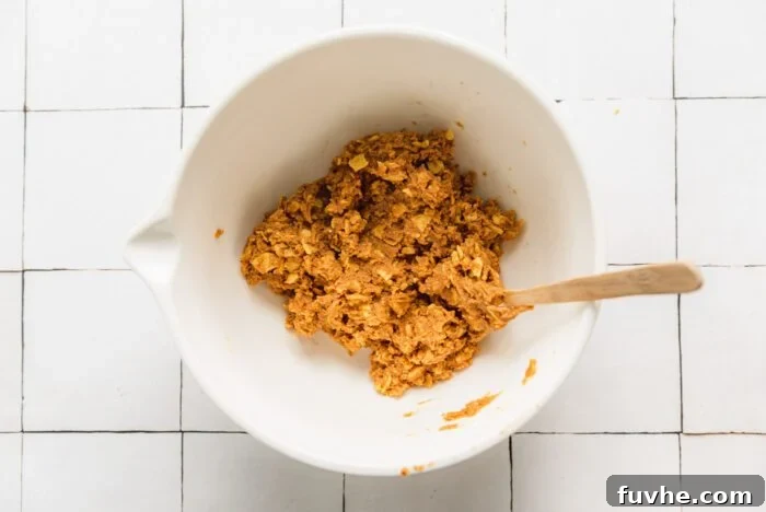 The doughy filling made from peanut butter and corn flakes for making homemade butterfingers in a bowl.