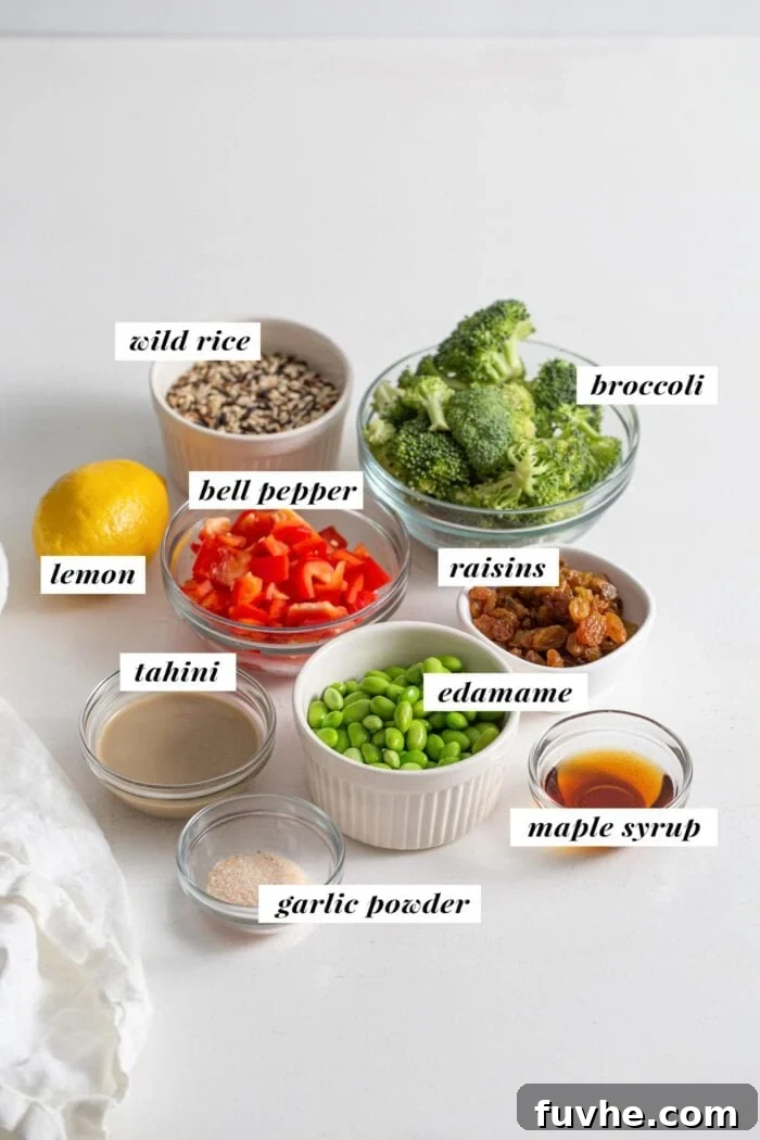 Rice, broccoli, lemon, tahini, edamame, maple syrup, raisins and chopped bell pepper in bowls. Labelled with text overlay.