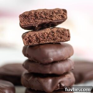 Stack of 4 Thin Mint cookies with one on top broken in half and stacked so you can see the texture inside the cookie.