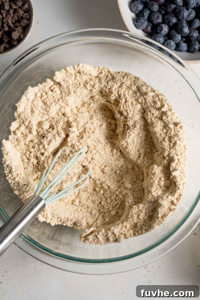 Flour in a mixing bowl with a whisk.