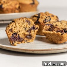 Sliced open chickpea flour chocolate chip muffin showing inside texture of muffin.