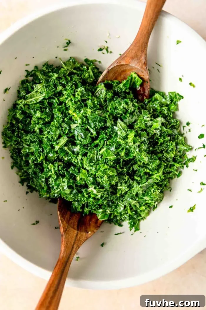 Vibrant Kale Quinoa Medley 4 Finely chopped kale leaves resting in a large mixing bowl, accompanied by a set of elegant wooden salad spoons.