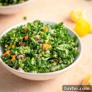 Vibrant Kale Quinoa Medley 8 A vibrant bowl of vegan kale quinoa salad with red onion, carrot, and cranberries, perfectly dressed and ready to eat.