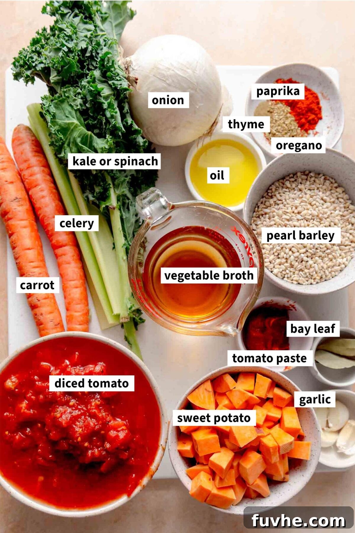 All the ingredients for a vegan vegetable barley soup recipe each labelled with text.