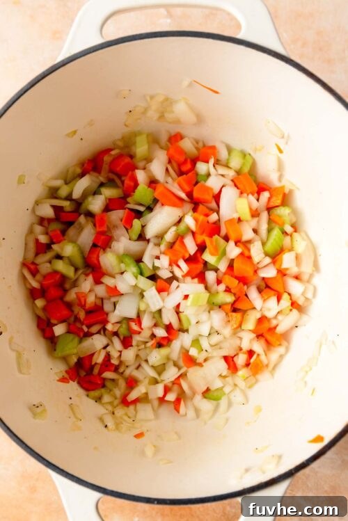 Celery, onion and carrot cooking in a large pot.