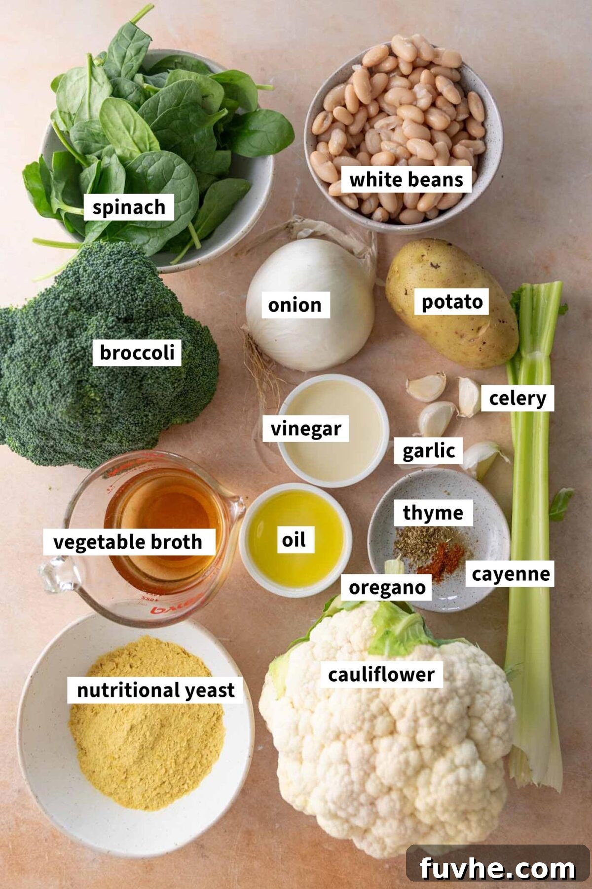 Velvety Vegan Broccoli & Cauliflower Bliss 3 All the fresh ingredients for making a healthy vegan broccoli cauliflower soup laid out, including white beans, onion, celery, nutritional yeast, and potato.