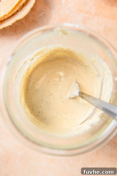 Crispy Buffalo Cauliflower Tacos 8 Creamy tahini ranch sauce in a glass jar with a fork.