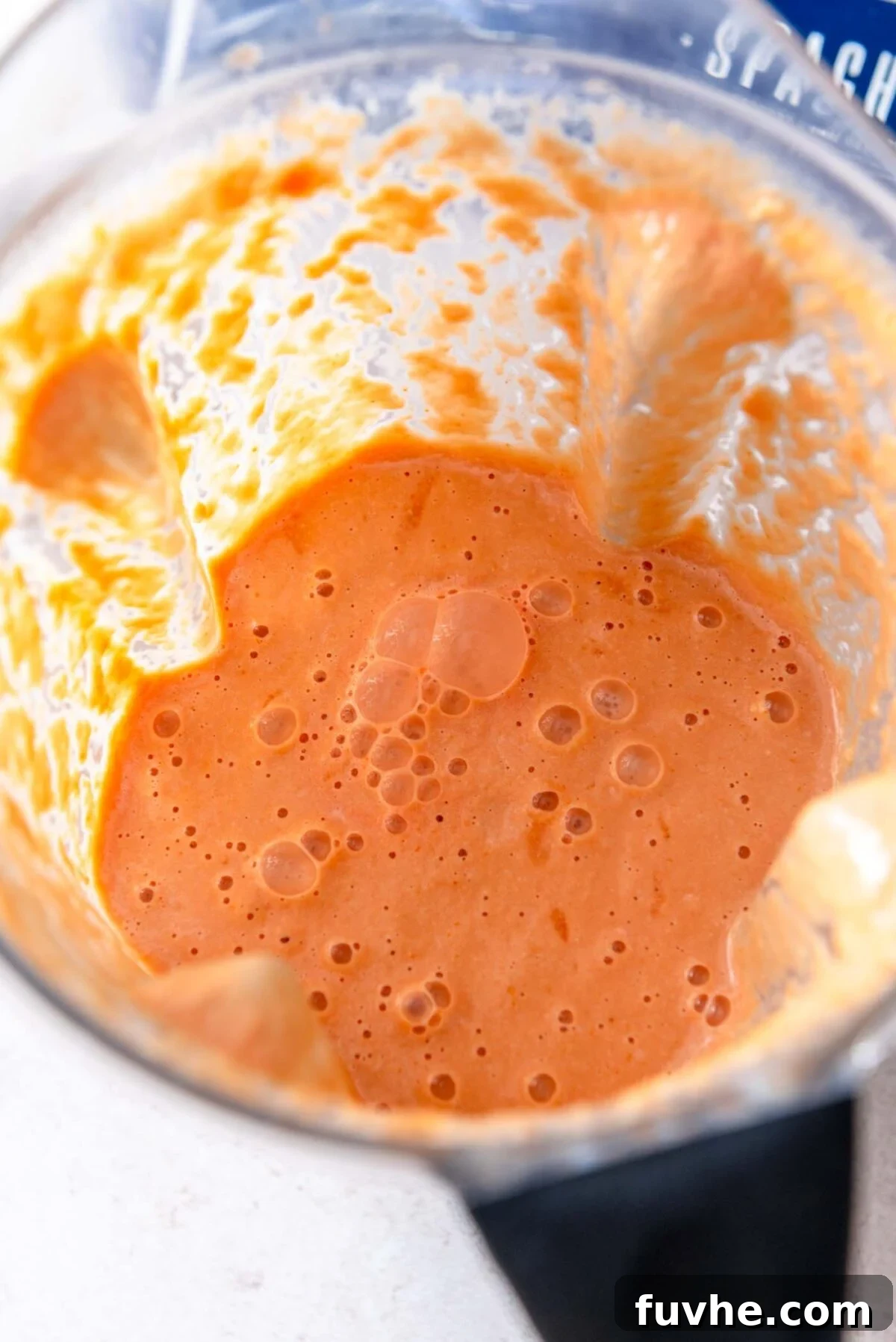 Creamy tomato sauce in a blender container.