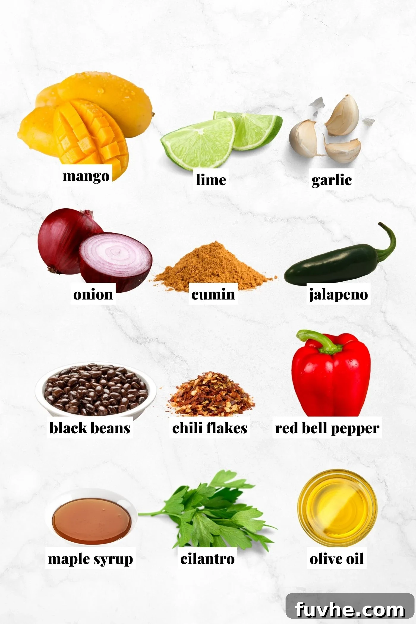 All the fresh ingredients laid out for making a delicious vegan black bean mango cilantro salad, including diced mango, black beans, bell pepper, red onion, and cilantro.