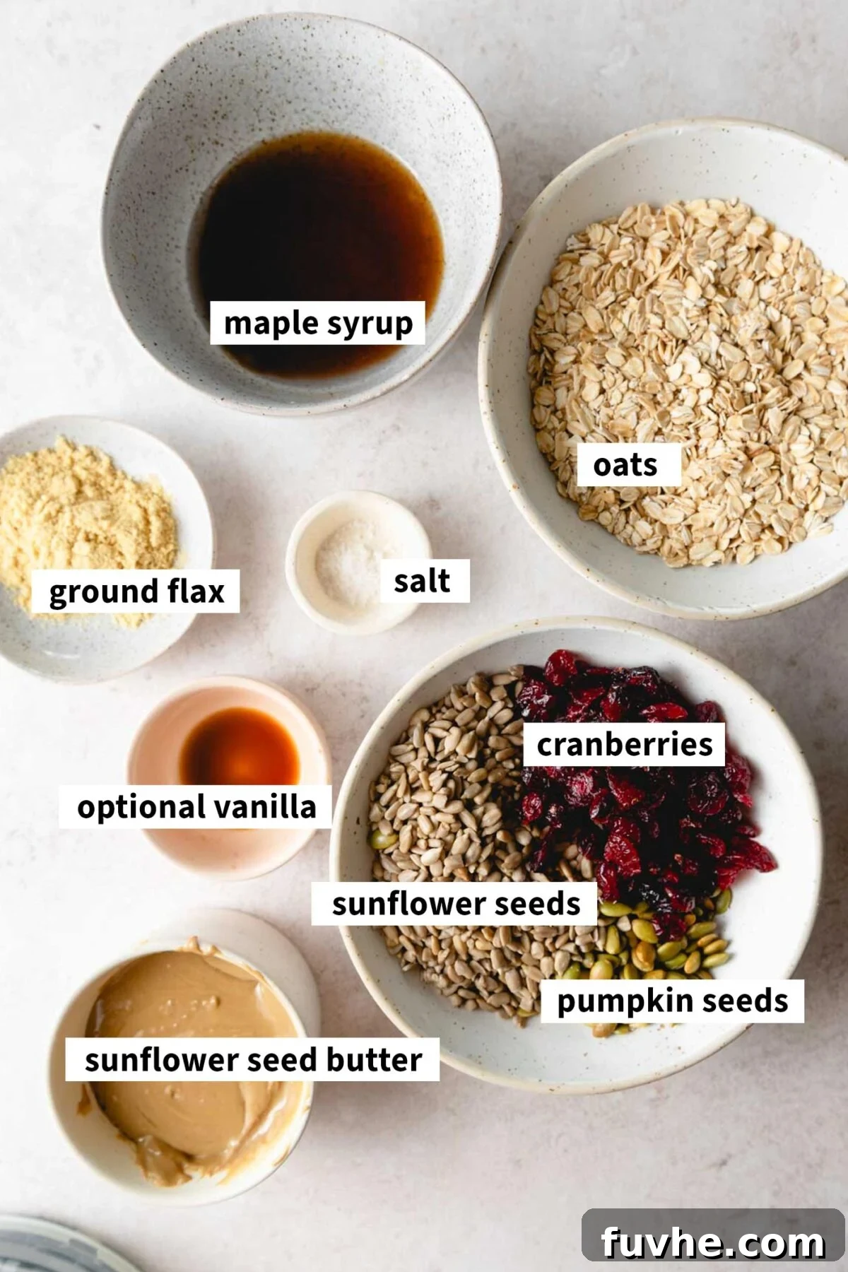 Wholesome Cranberry Granola Bars 3 A colorful and organized arrangement of all the essential ingredients, including oats, dried cranberries, and various seeds, laid out for preparing healthy vegan granola bars.