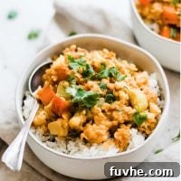 White bowl filled with red lentils and vegetables.