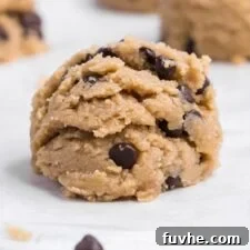 Close up of scoops of chocolate chip cookie on a baking sheet.