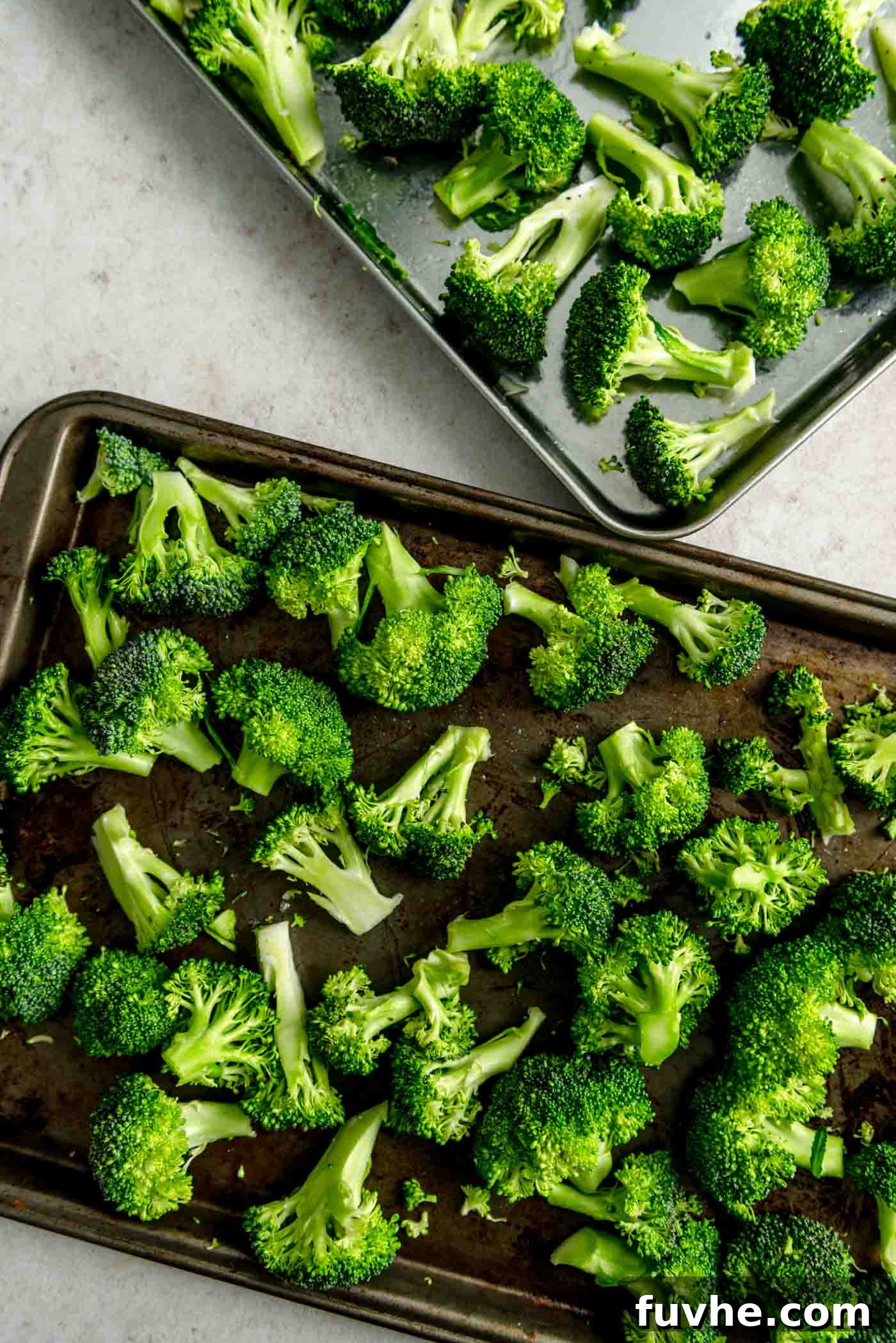 Broccoli florets on baking sheets.