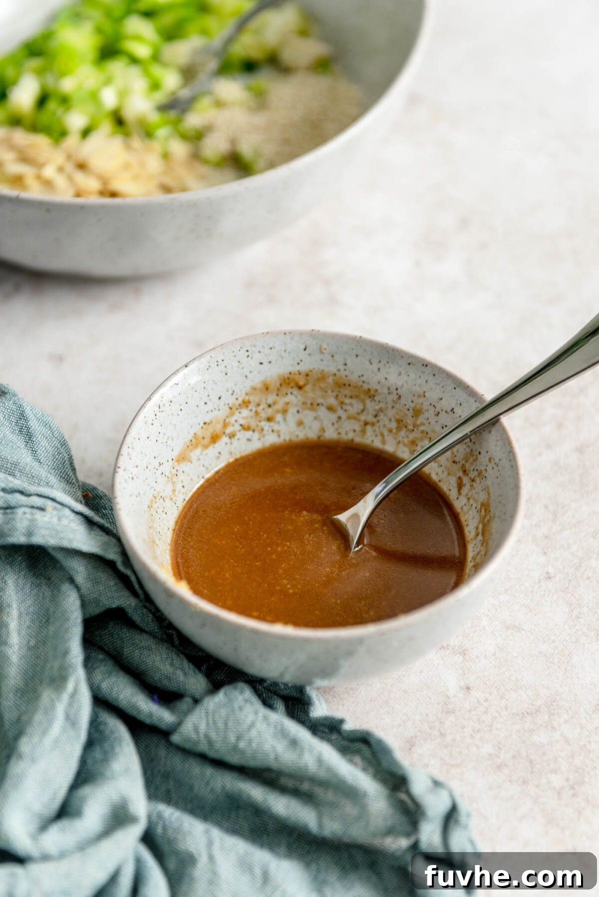 Miso dressing in a bowl with a spoon.