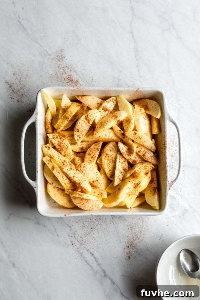 Chopped and peeled apples in a baking dish.