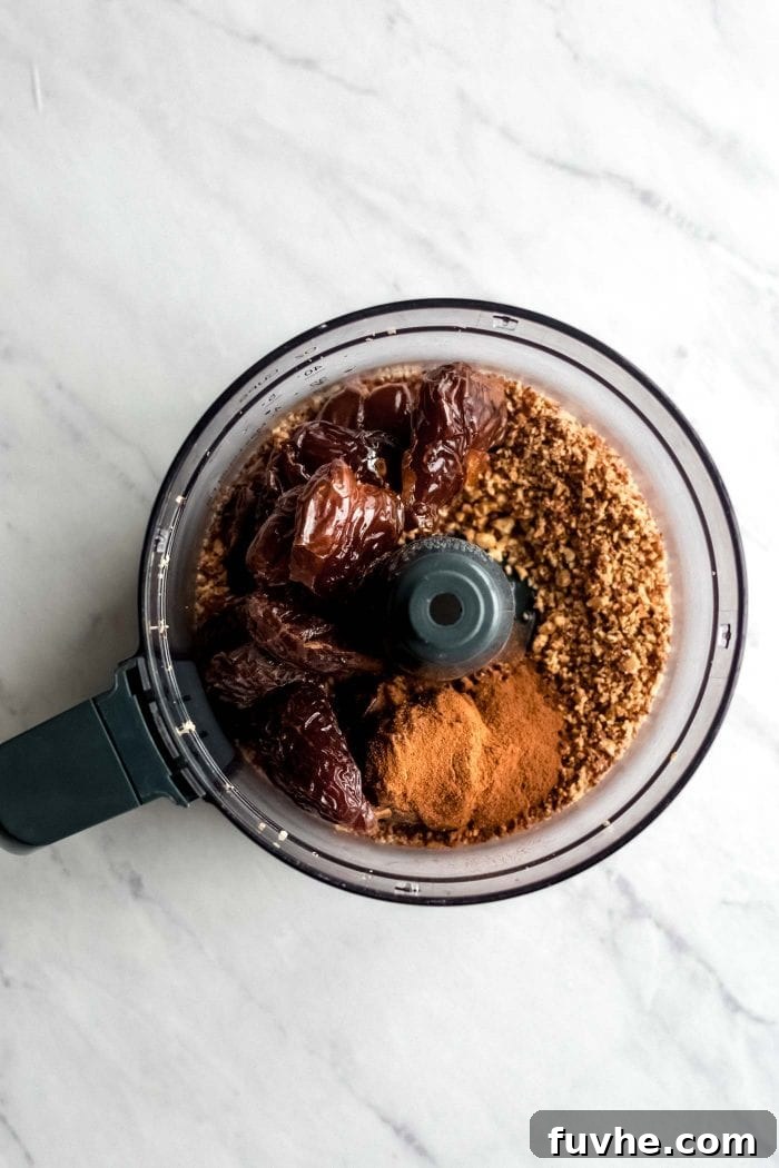 Grain-free apple crisp crust ingredients in a food processor.