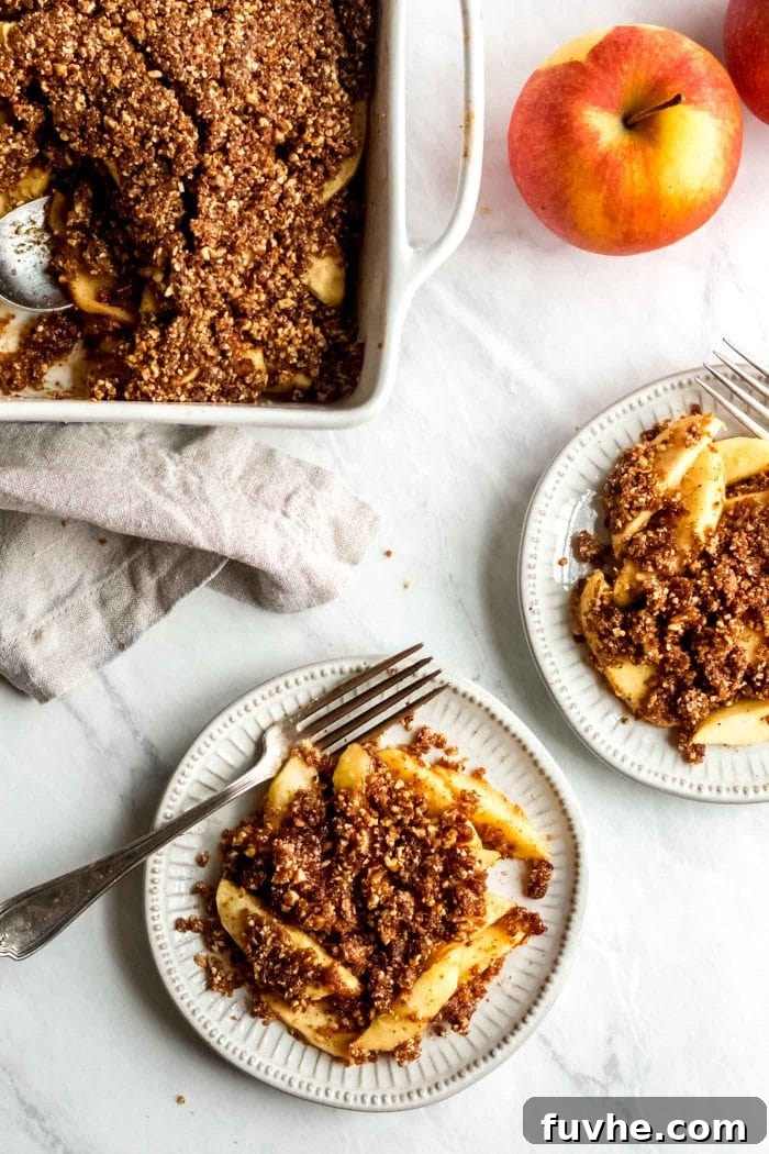 Two plates of grain-free healthy vegan apple crisp.