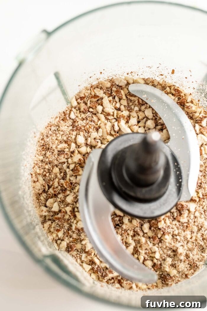 Blended almonds in a food processor container.