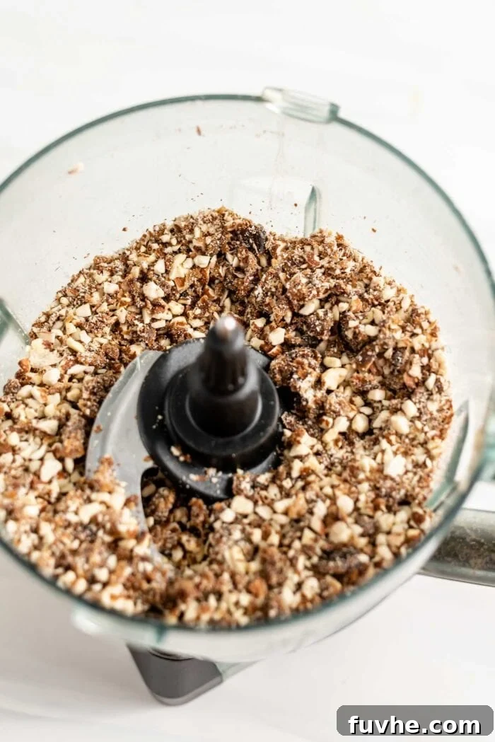 Blended dates and almonds in a food processor.