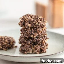 Stack of 4 chocolate no-bake oatmeal cookies on a small plate.