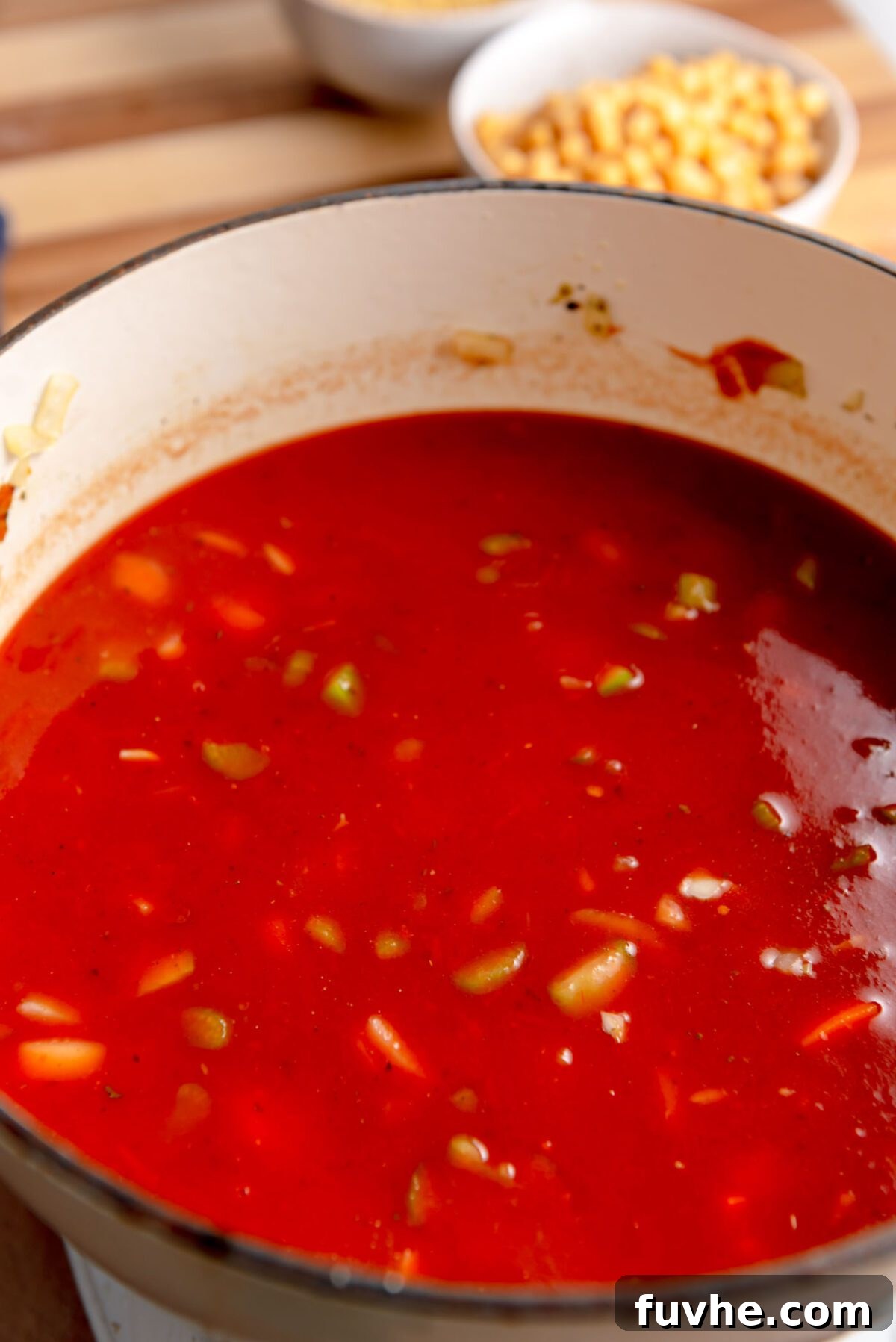 Vibrant Tomato Orzo Soup 6 Rich red tomato soup gently simmering in a large pot, its warmth and aroma filling the kitchen.