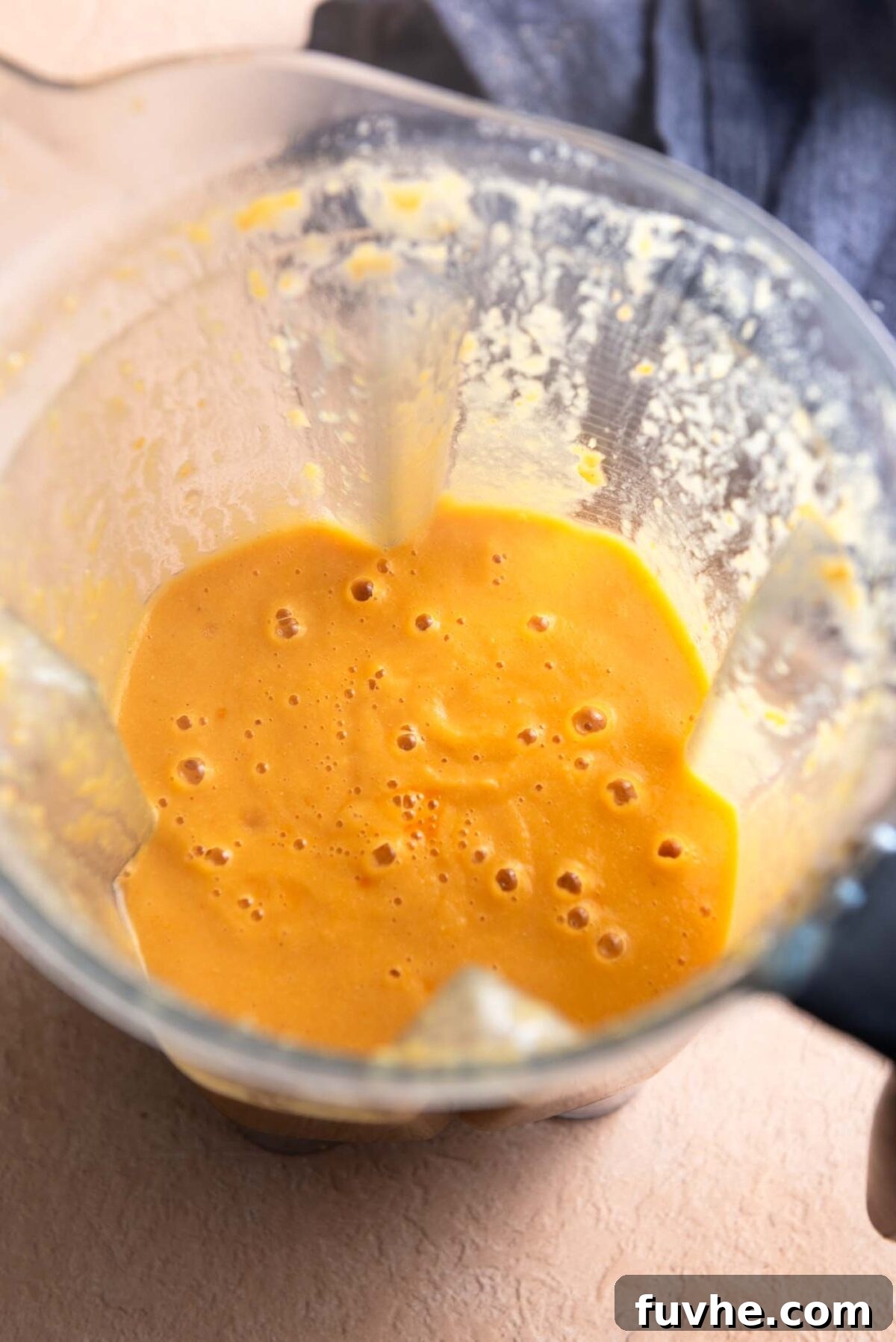 Blended creamy curry soup in a blender container.