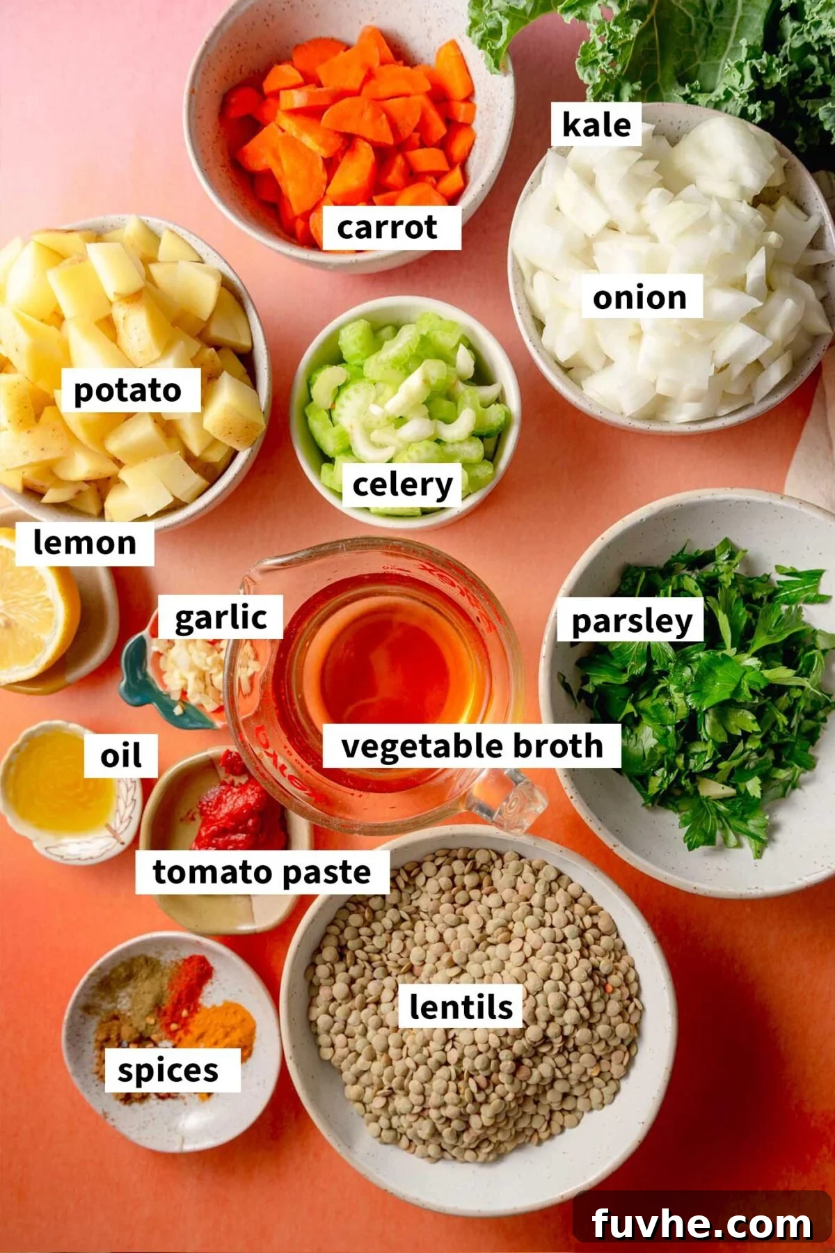Hearty Lentil Potato Soup 3 All the ingredients gathered for making a vegan potato lentil soup with carrot, celery and kale. Each ingredient is labelled with text.