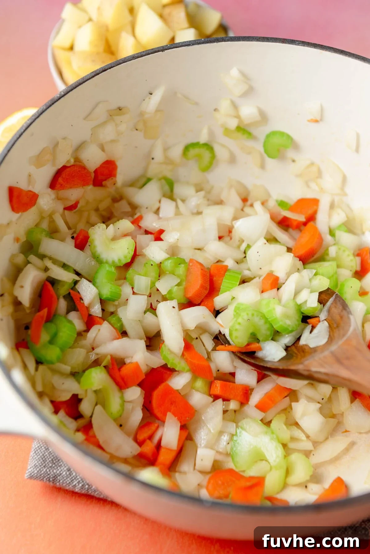 Hearty Lentil Potato Soup 4 Chopped celery, onion and carrot cooking in a soup pot.