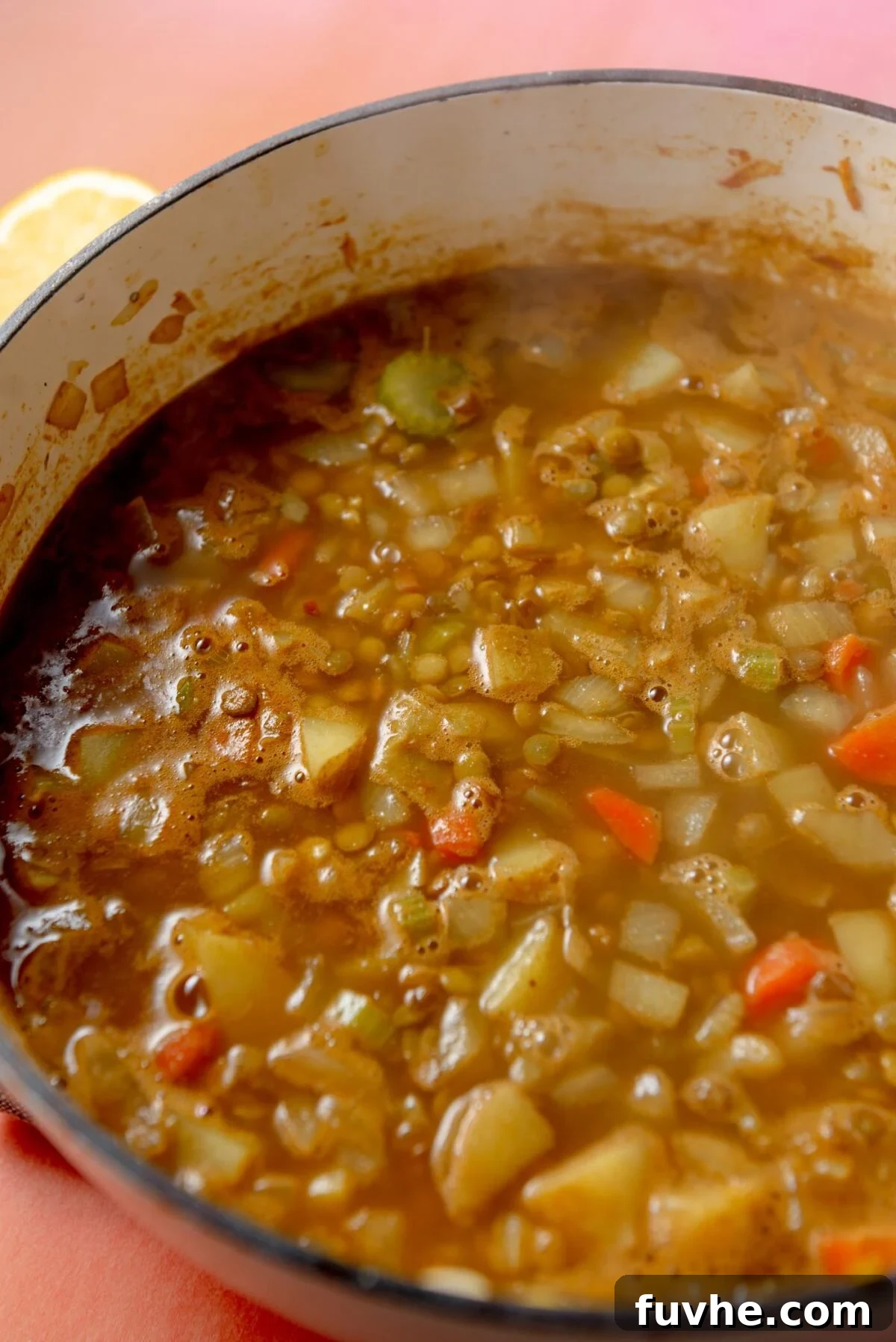 Hearty Lentil Potato Soup 7 Potato lentil soup cooking in a large pot.