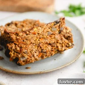 A vibrant and appetizing image of a lentil loaf with a rich, dark glaze, served on a rustic wooden board, ready to be sliced and enjoyed.