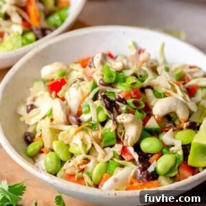 Vibrant Edamame Medley 9 Bowl of edamame bean salad with cabbage, cucumber, bell pepper and cashews.