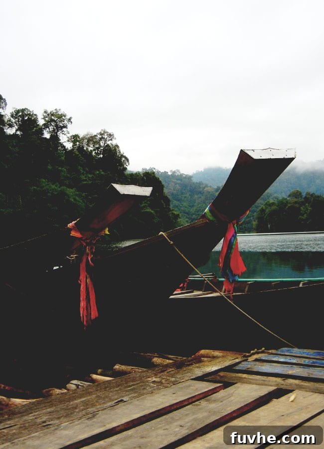 Two longtail boats navigating the vast expanse of Chiew Lan Lake