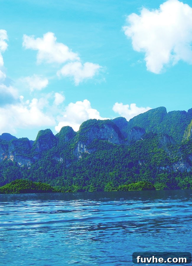 Dramatic limestone karsts rising from Chiew Lan Lake, Khao Sok National Park