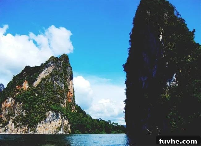 Longtail boat gliding through Chiew Lan Lake in Khao Sok National Park