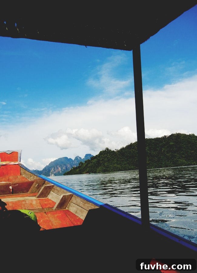 Rustic floating huts nestled against the jungle on Chiew Lan Lake