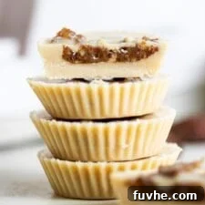 A stack of 4 tahini cups with dates inside, one cut in half to show inside.