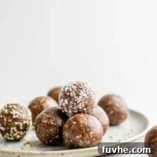 A stack of raw energy balls on a plate.
