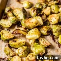 Caramelized Maple Dijon Brussels Sprouts 9 Maple dijon roasted brussel sprouts on a baking tray lined with parchment paper.