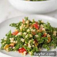 Wholesome Kale and Barley Salad 5 A plate of Kale Barley Salad, showcasing the rich textures and colors of the ingredients: barley, kale, bell peppers, pistachios, and raisins.