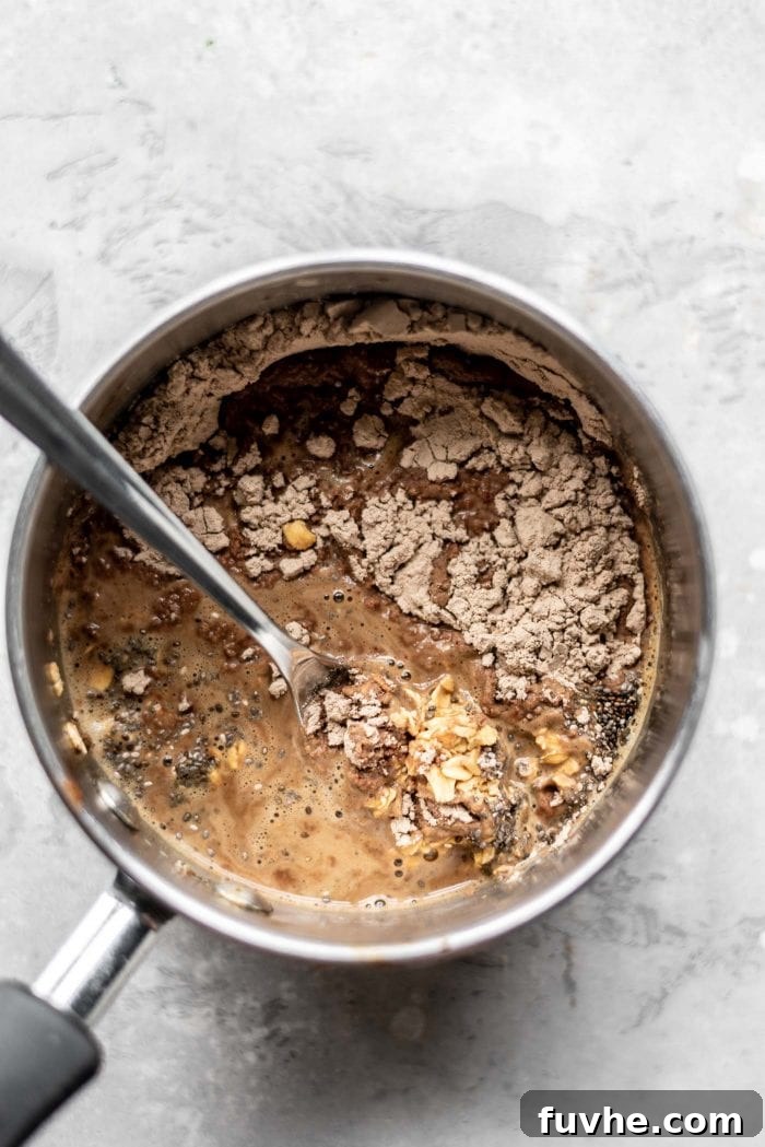 A saucepan filled with oats, freshly brewed coffee, and vegan protein powder, ready to be cooked into a delicious and energizing breakfast.