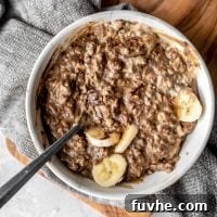 Bowl of vegan mocha protein oatmeal with banana and cashew butter.