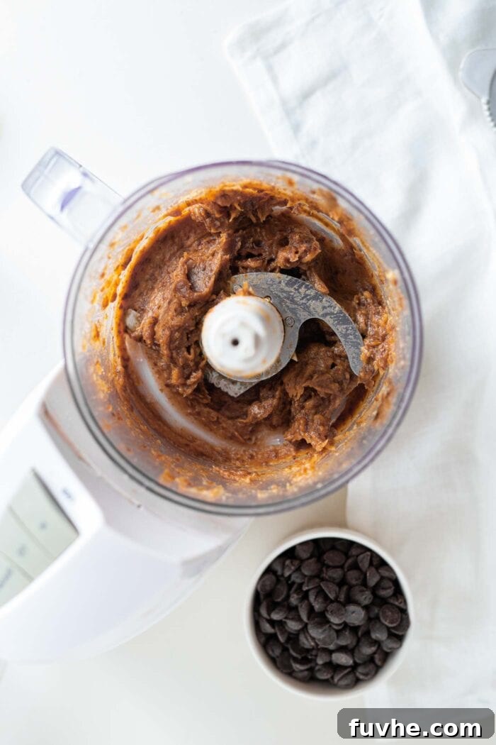 Smooth, creamy date paste blended in a food processor, ready to become the caramel center.